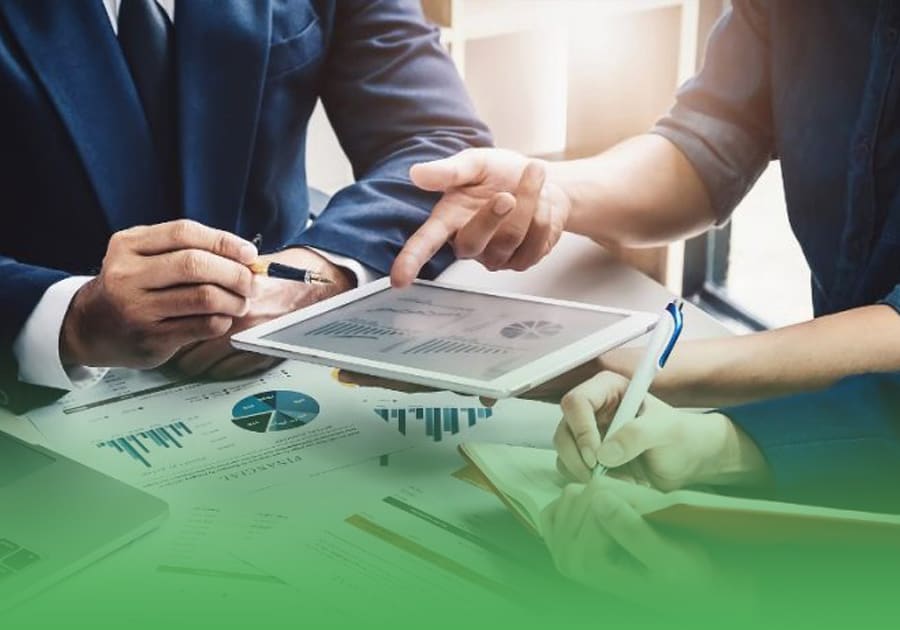 financial data on an iPad screen and financial documents on an office desk being reviewed by a person and an investor