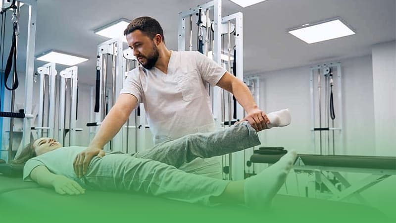 Chiropractic business owner conducts physical therapy session with patient focusing on rehabilitation and healing.