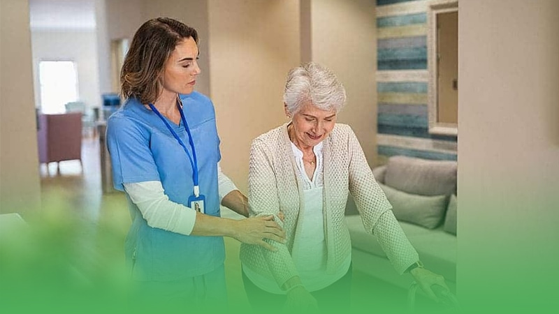 Caring nurse assists elderly woman with walker in senior care business.