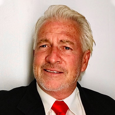 Distinguished man named Michael Throckmorton with white hair and red tie