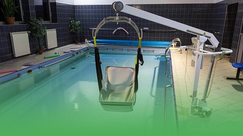Pool in assisted living facility business featuring lift and chair for accessibility and comfort.