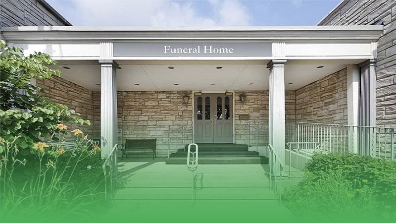 Front entrance to home displaying sign indicating funeral home business.